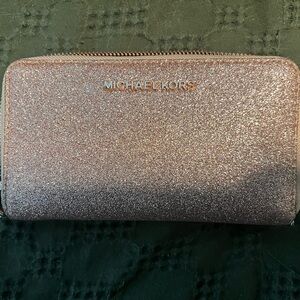Michael Kors rose gold wallet.